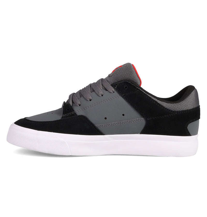 The DC Shoes Men's Onyx is a low-top vulc shoe with a minimal silhouette, featuring a gray and black upper, gray laces, white rubber sole, and a red accent on the tongue—shown in side profile facing left.