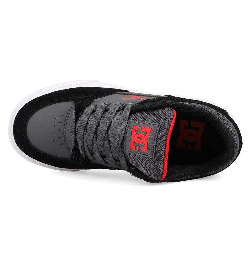 Top view of DC Shoes Kids' Onyx Shoes in black with black laces, white sole, and red DC logo on the tongue—an everyday sneaker.