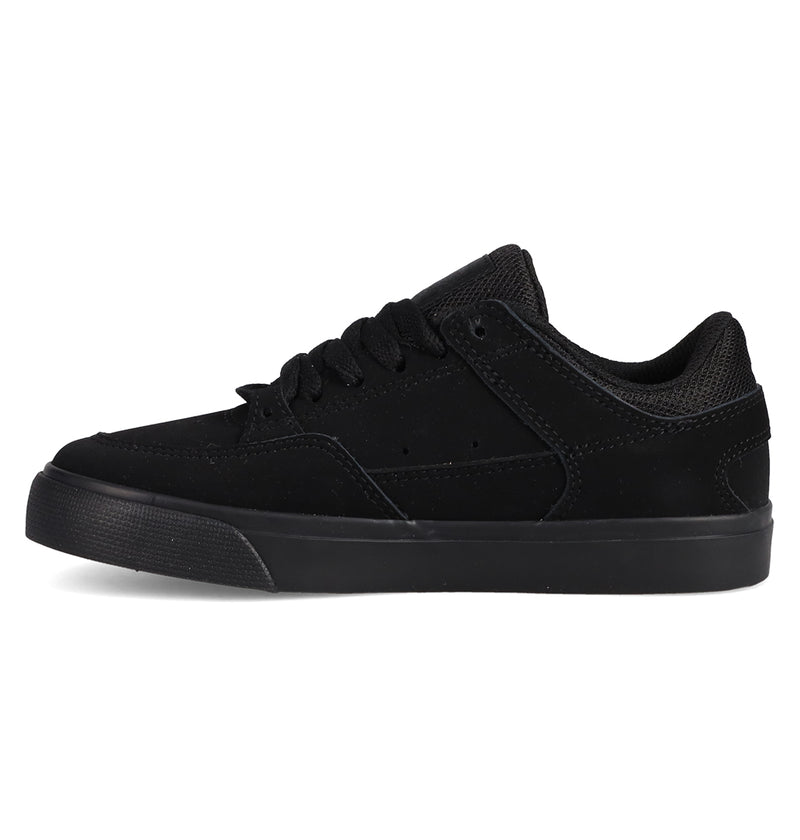 The Kids' Onyx Shoes by DC Shoes are black low-tops with a suede and mesh upper, black laces, and a black rubber sole. Shown in side view against a white background, they feature a minimal silhouette perfect for everyday wear.