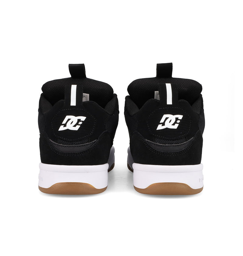 A pair of black DC Shoes Men's JS-2 Shanahan Pro Skate Shoes seen from the back, featuring white DC logos on the heels, white midsoles, and brown rubber outsoles—highlighting classic brand style with John Shanahan influence.