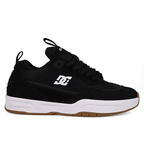 The DC Shoes Men's JS-2 Shanahan Pro Skate Shoes feature a black upper, white side logo, black laces, thick white midsole, and brown rubber outsole. Inspired by John Shanahan and shown on a plain white background.
