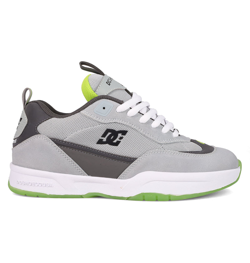 The Men's JS 2 Shoes by DC Shoes feature a gray and black colorway with white laces, a white midsole, neon green details, and a textured green outsole—iconic John Shanahan collection style shown in side profile.