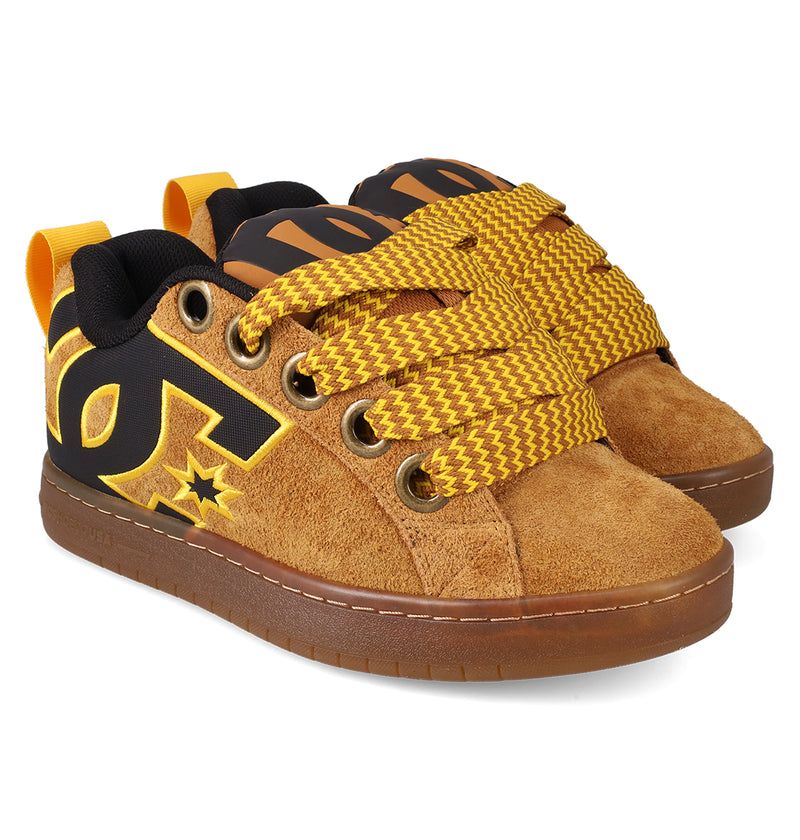 The DC Shoes Men's Court Graffik Puff features brown suede, a chunky silhouette, thick yellow/brown zigzag laces, bold black and yellow DC logos on the sides, and yellow pull tabs—ideal for fans of standout sneaker details.