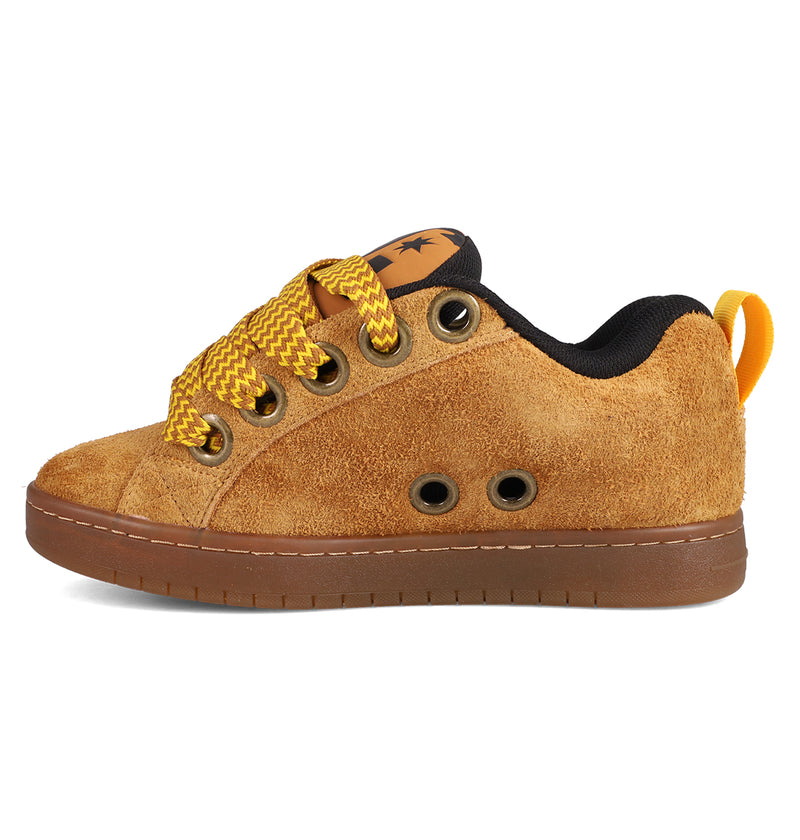 The DC Shoes Men's Court Graffik Puff Shoes feature a tan suede upper, puffy silhouette, yellow/brown striped laces, black interior, brown sole, metal eyelets, and a yellow heel pull tab—showcasing fresh colorways in a side view.