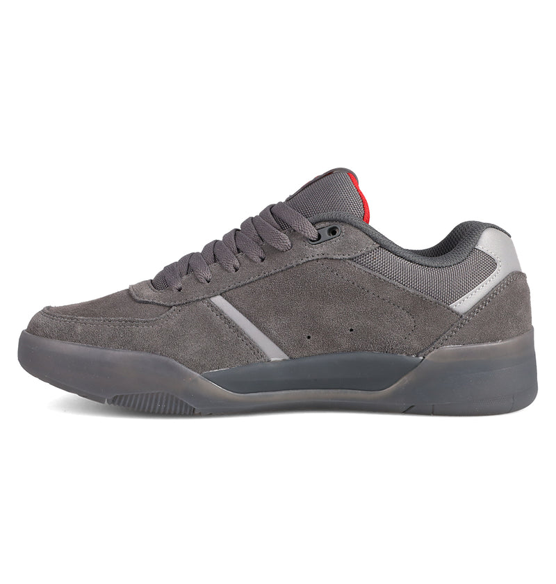 The DC Shoes Men's Fractal SE features gray suede, dark gray laces, a thick rubber sole, a small red tongue tag, and subtle reflective accents near the heel for style and comfort.