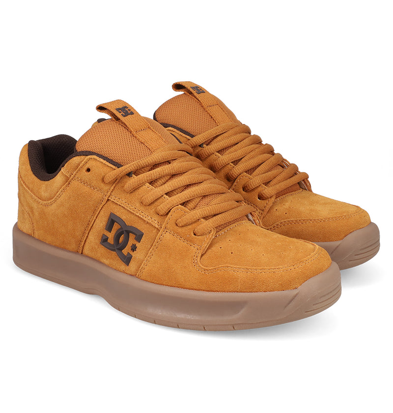 A pair of Men's Lynx Zero SE Shoes by DC Shoes in tan suede, featuring brown soles, matching tan laces, and black DC logos on the sides and tongue, displayed against a white background.