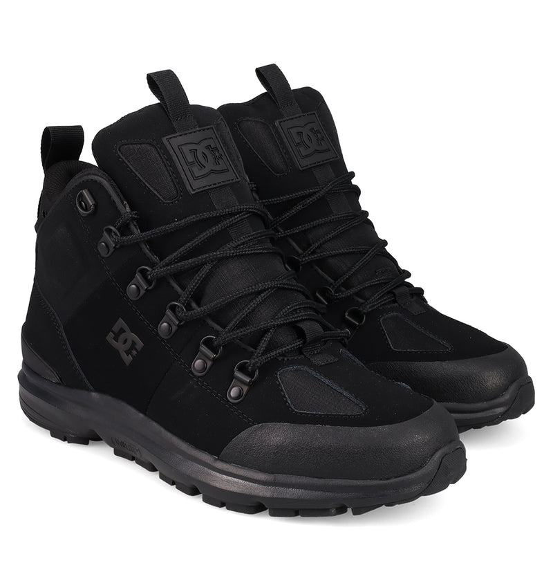 The men's DC Tarmont Shoes by DC Shoes, black high-tops with thick rubber soles, lace-up fronts, and DC logos on the sides and tongues, are displayed at a slight angle against a white background for street-ready style.