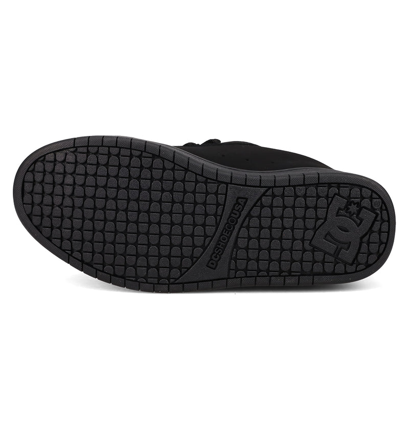 The image features the black rubber sole of the DC Shoes Men’s Court Graffik Day Of The Dead sneaker, displaying a textured tread pattern and the DC Shoes logo near the heel, from their vibrant Day of the Dead Collection inspired by Día de los Muertos.