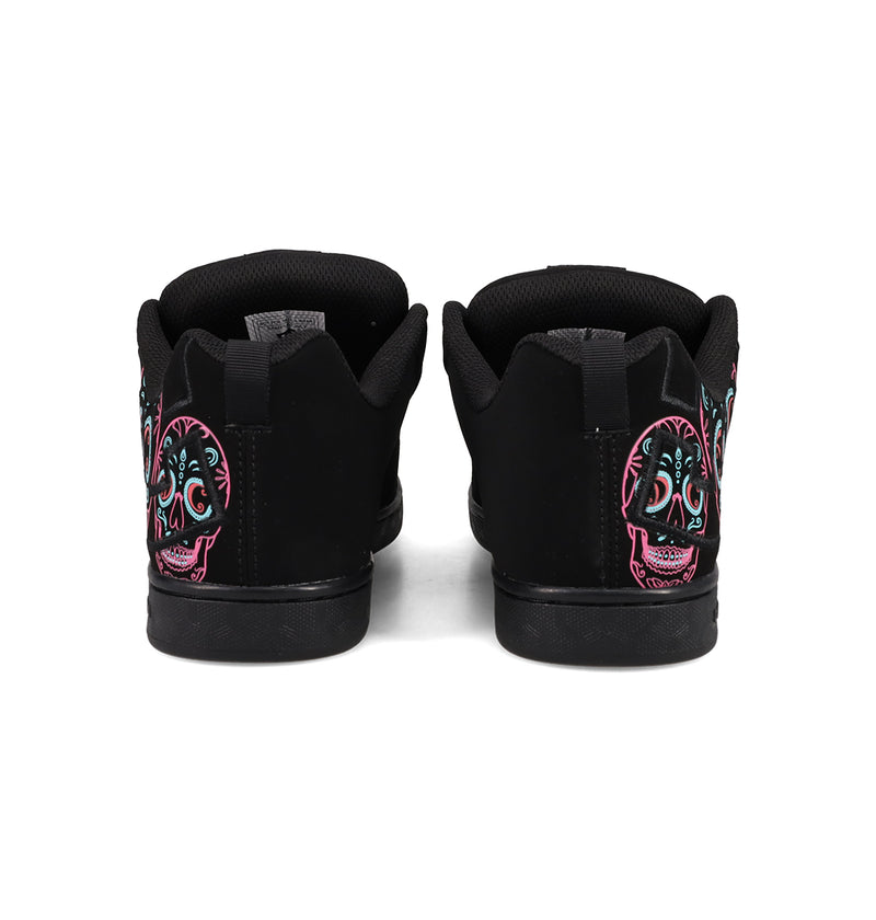 A pair of Women’s Court Graffik Day Of The Dead sneakers by DC Shoes viewed from the back, showcasing vibrant sugar skull designs in pink, teal, and white on the heels—a bold and striking addition to any Día de los Muertos Day of the Dead collection.