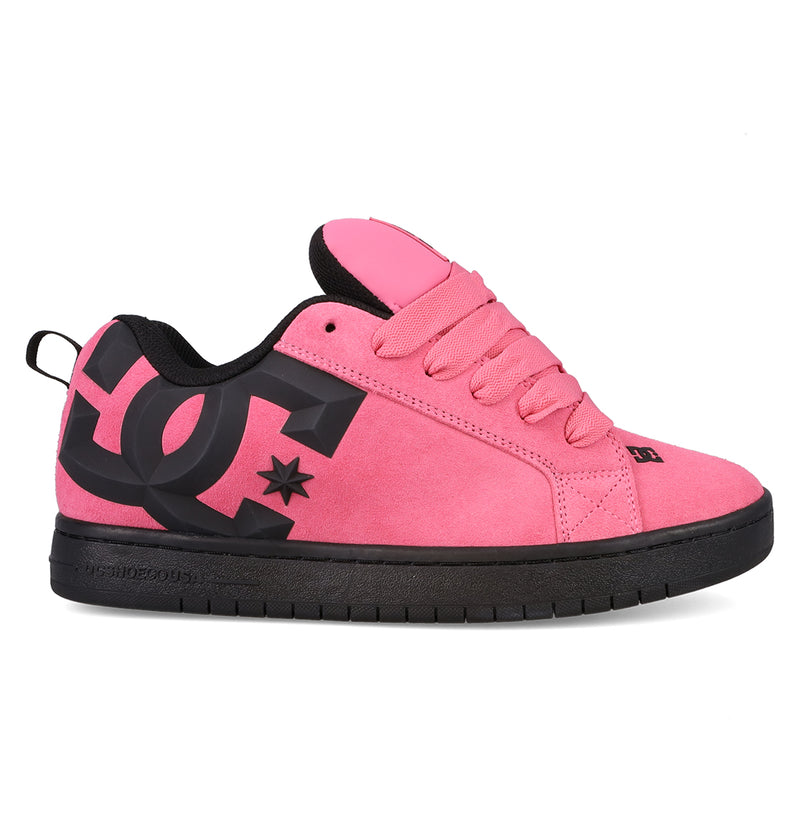The DC Shoes Men’s Court Graffik Beveled Special Edition Shoes are shown in a side profile on a white background, featuring a pink puffy silhouette with a large black DC logo on the side, black sole, pink laces, and black interior lining.