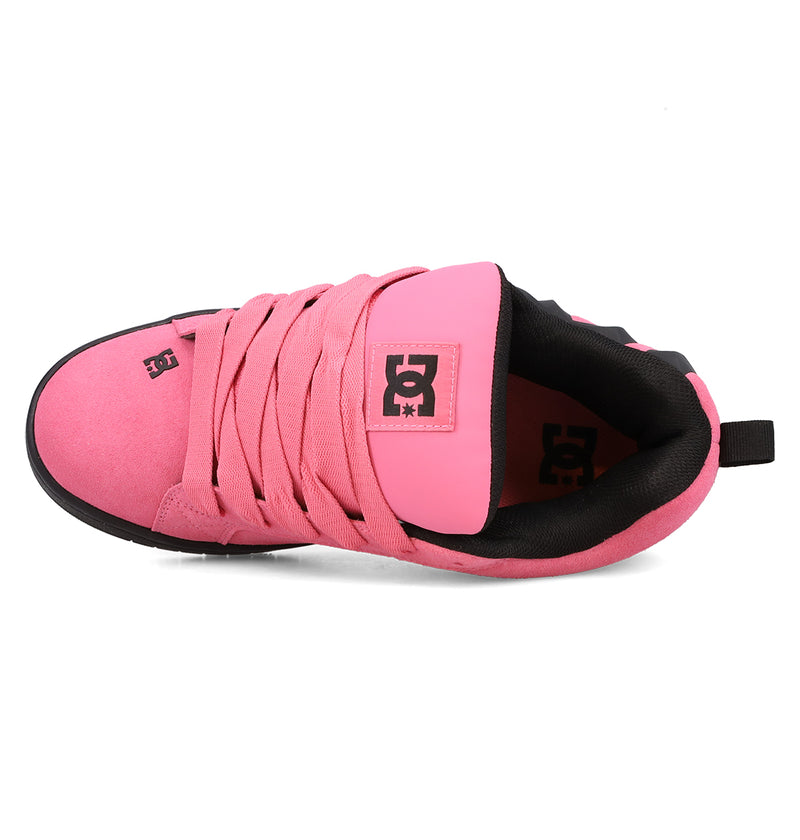 A top view of the Men’s Court Graffik Beveled Special Edition Shoe by DC Shoes in pink with black accents, featuring wide laces and prominent DC branding on the tongue and insole. The puffy silhouette sneaker is displayed isolated on a white background.