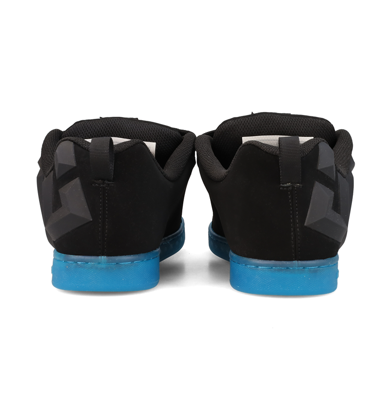 A pair of Women’s Court Graffik Beveled Shoes by DC Shoes is shown from the back. These sneakers feature a puffy silhouette with geometric patterns on the heels, distinct DC branding, and black uppers with blue soles, all set against a white background.