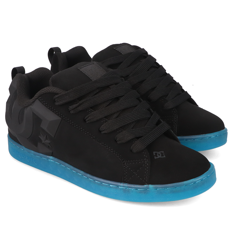 A pair of Women’s Court Graffik Beveled Shoes by DC Shoes, featuring a puffy black silhouette, thick black laces, and vibrant blue soles, are displayed side by side at a slight angle on a white background. The bold DC branding and distinctive beveled design give these skate sneakers unmistakable street style.