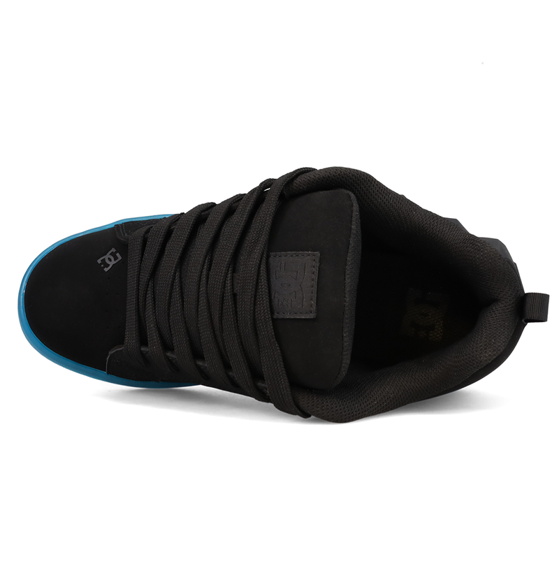 A top view of the Women’s Court Graffik Beveled Shoes by DC Shoes showcases a black sneaker with thick black laces, a padded tongue, and a blue sole peeking out at the toe. Featuring DC Shoes’ signature puffy silhouette, this style appears to be crafted from suede and fabric with subtle DC branding on the side.