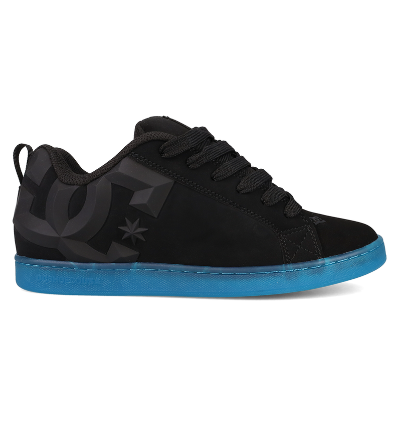 The Women’s Court Graffik Beveled Shoes by DC Shoes are black sneakers highlighted by a large dark gray DC logo on the side and a vibrant blue sole. Featuring a puffy silhouette, they are displayed from the side against a white background.