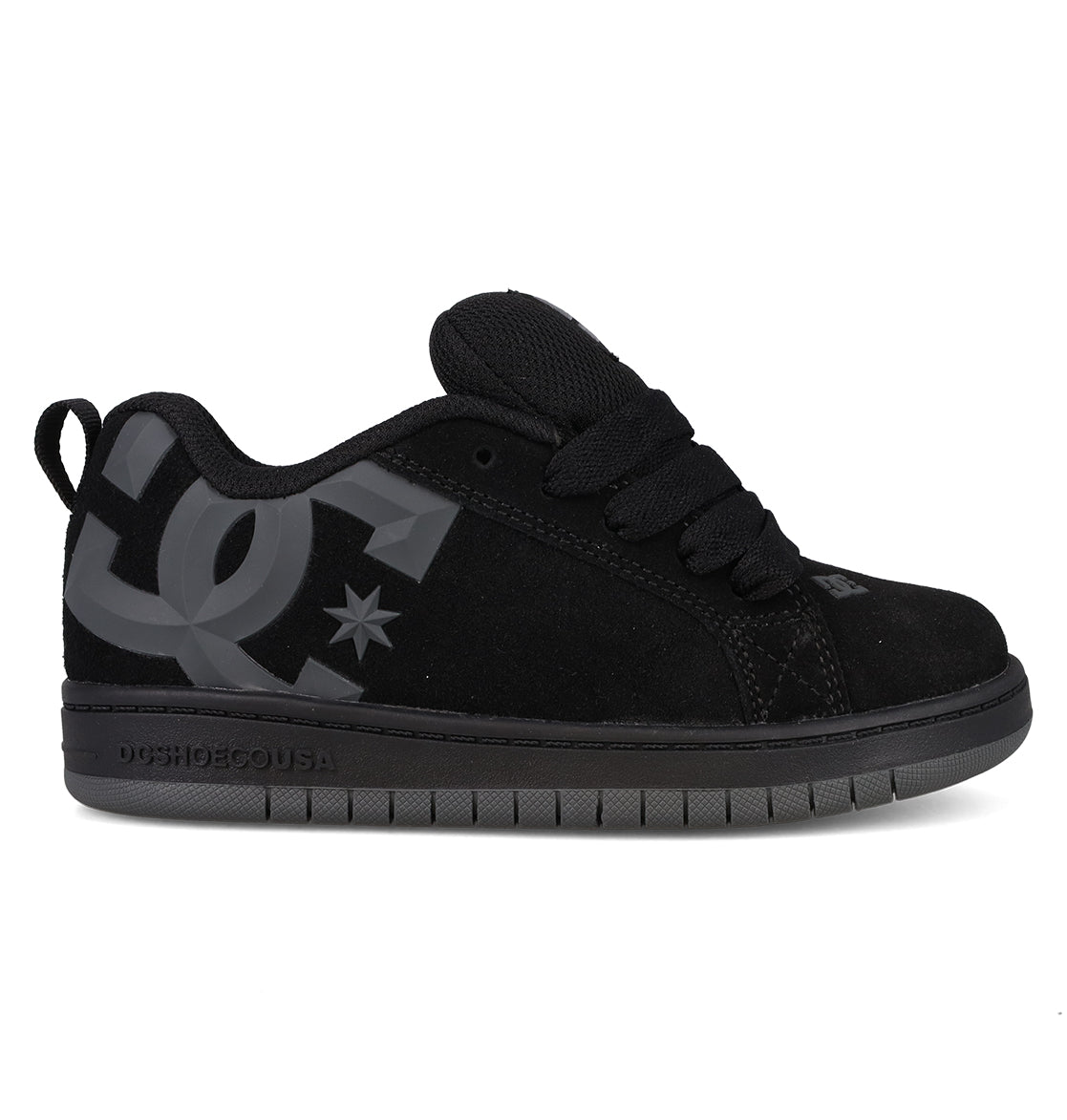 A side profile view of the DC Shoes Kids’ Court Graffik Beveled Special Edition features a black skate shoe with a puffy silhouette, thick laces, a large gray DC logo on the side, and a dark gray sole, displayed on a white background.