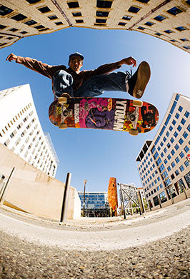 Person skateboarding in an urban setting with buildings in the background