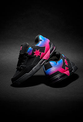 Black sneakers with colorful gradient pink and blue designs on a dark background