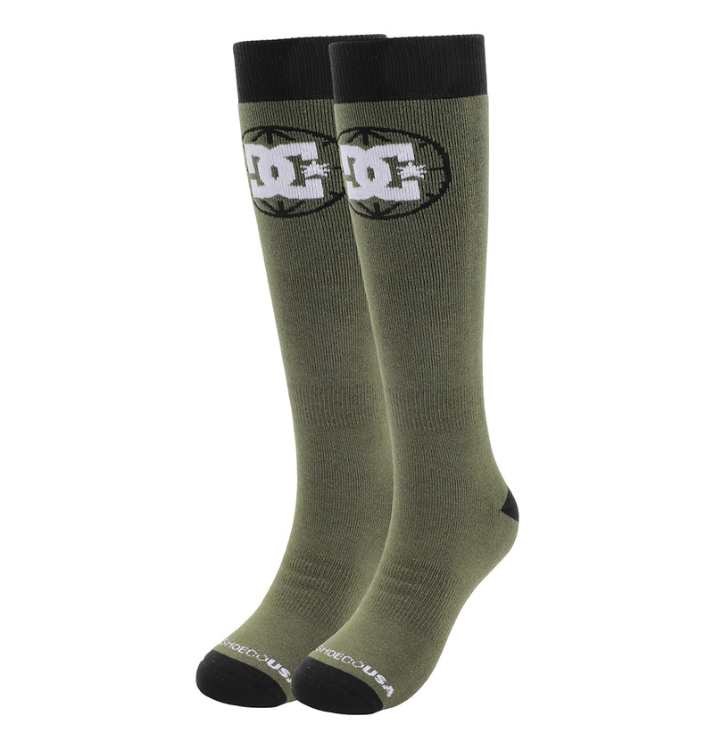 The DC Shoes Performance Socks 2-Pack includes olive green knee-high socks with black cuffs, toes, and heels, featuring a white and black DC Shoes logo near the top and "DC SHOES USA" text in white on the toes.