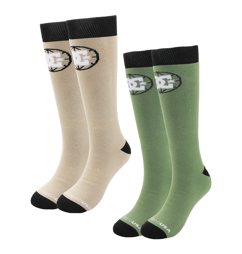 The DC Shoes Performance Socks 2-Pack includes beige and green knee-high socks, each with black toes, heels, cuffs, and a black-and-white star logo on the upper sides.