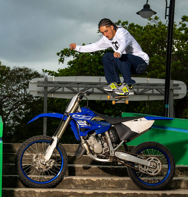 Man doing skateboard trick wearing the AT-2 shoes
