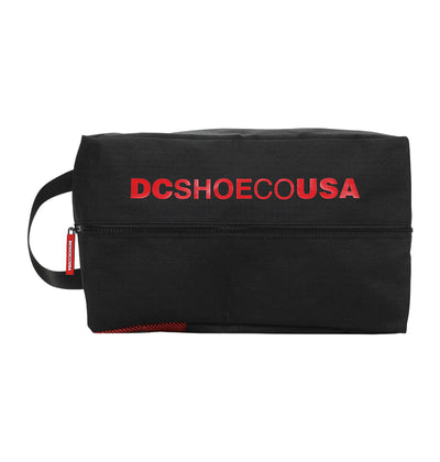 The DC Runner Shoe Bag by DC Shoes is a black rectangular pouch with a side handle, bold red "DCSHOECOUSA" text on the front, and a horizontal zipper.
