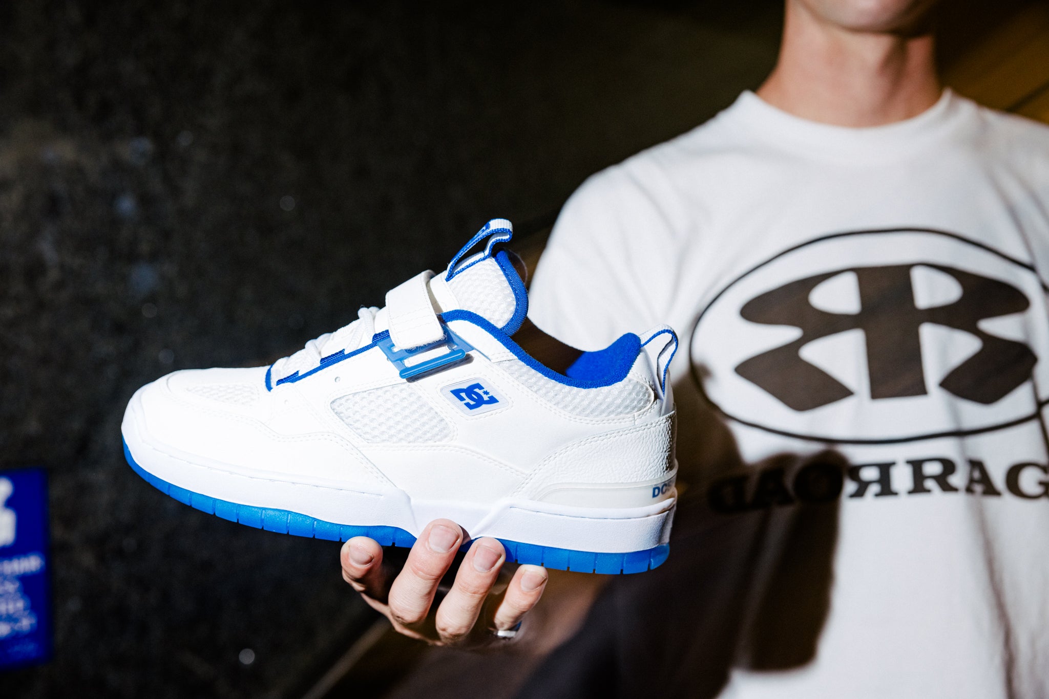 John Shanahan holding the white and blue Shanahan shoes