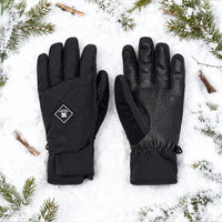 Black gloves on a snowy background with pine branches.