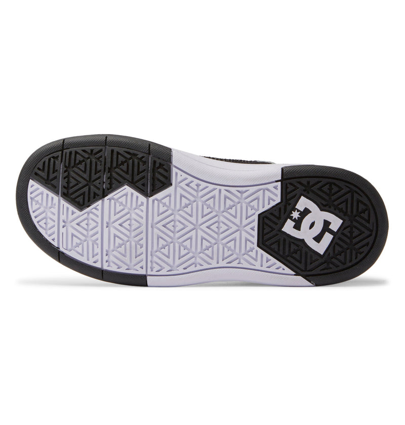 The image displays the sole of the Kids' Cure High-Top Shoes by DC Shoes, featuring a geometric black and white tread, an abrasion-resistant rubber outsole, and the white DC Shoes logo on the heel.