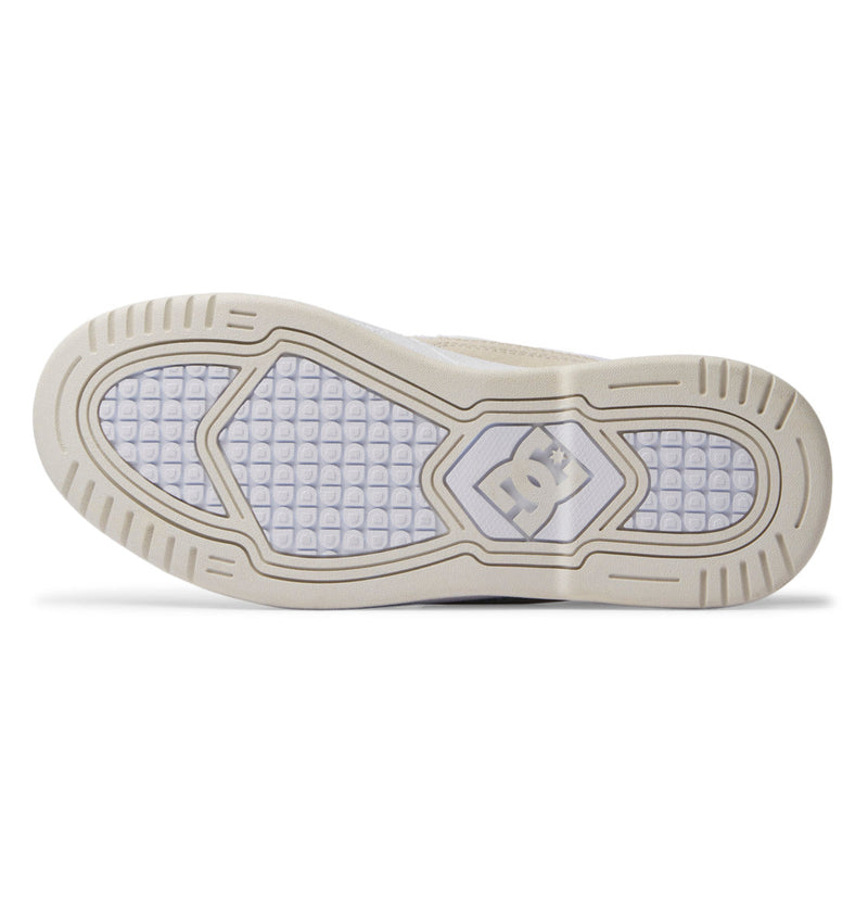 The image displays the sole of the DC Shoes Women's Construct Shoes, featuring a beige rubber outer edge, a grid-patterned translucent center, and the DC Shoes logo near the arch.