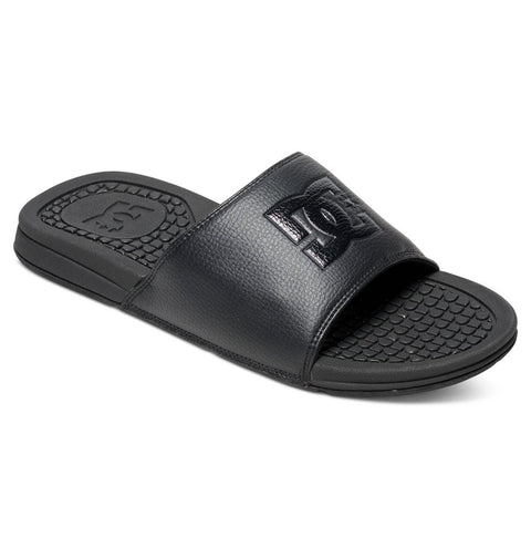 The DC Shoes Men's Bolsa Slides feature a wide strap with an embossed logo and a textured footbed for grip and comfort—perfect for everyday wear or relaxing after skating.