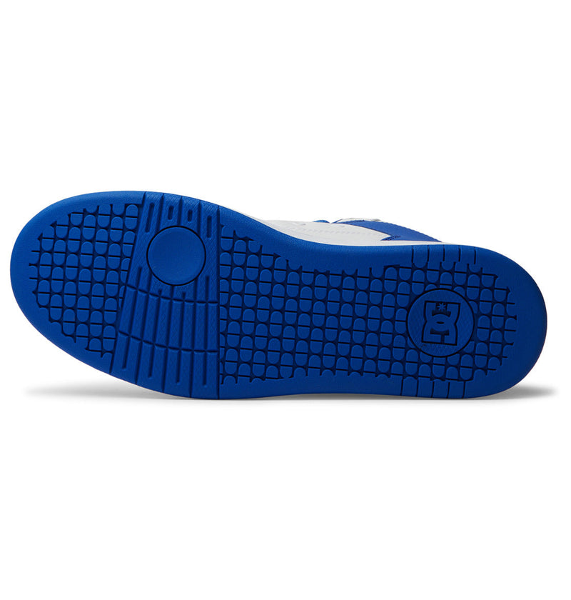 The image displays the Men's Manteca 4 HI Shoes by DC Shoes, featuring a blue rubber outsole with a textured tread pattern and a small cartoon character logo near the heel, emphasizing its durable design.