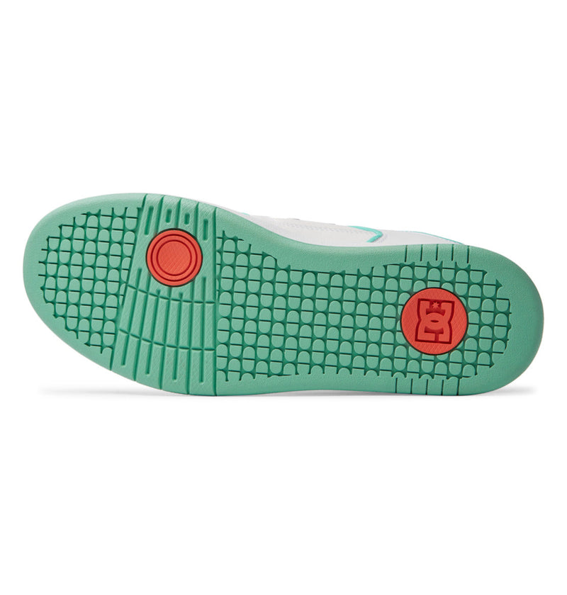 The image shows the sole of a DC Shoes Men's Manteca 4 SE with a mint green, textured hexagonal tread, two circular red accents, and a red square with the crown logo near the heel—designed for style and performance.