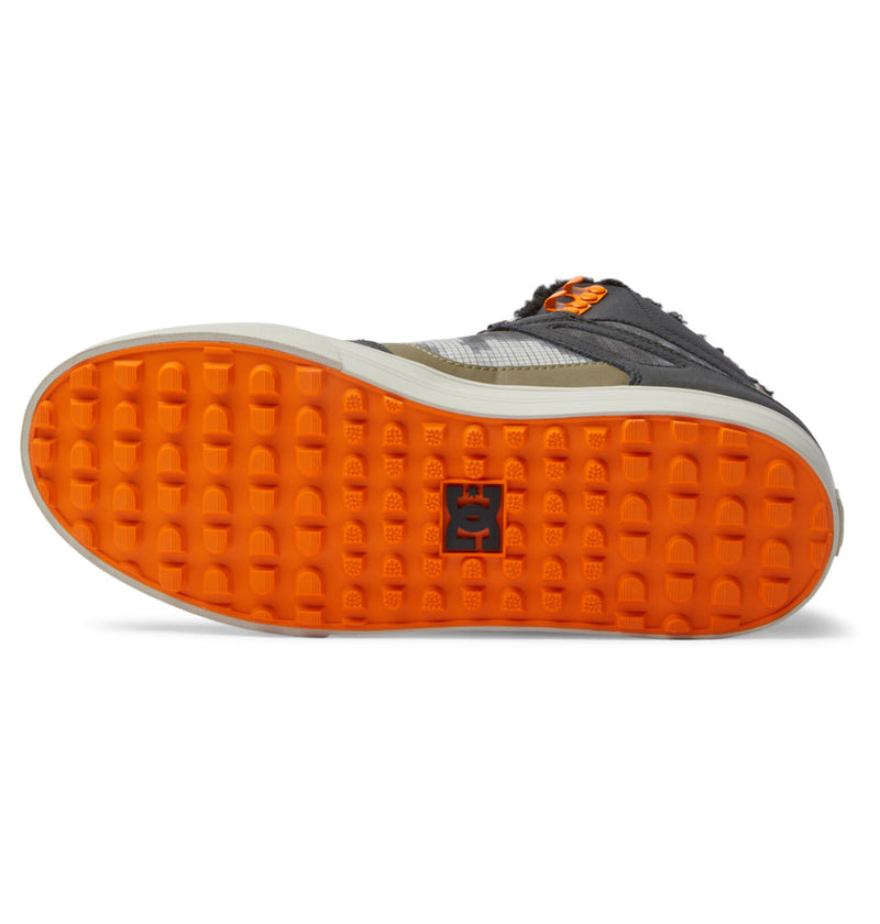 Close-up of a shoe with orange sole on a white background