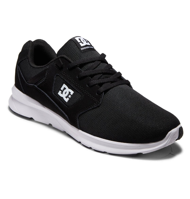 The DC Shoes Men's Skyline Lightweight black sneaker, made with nubuck leather mesh, features a white sole, black laces, and a white DC logo on the side—shown angled to display both its side and front sporty street style.