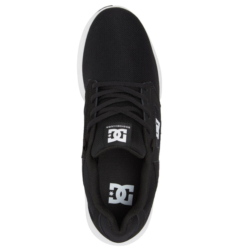 Top view of Men's Skyline Lightweight Shoes by DC Shoes in black nubuck leather mesh, featuring white logo details on tongue and insole, black laces, and a white sole, photographed on a white background.