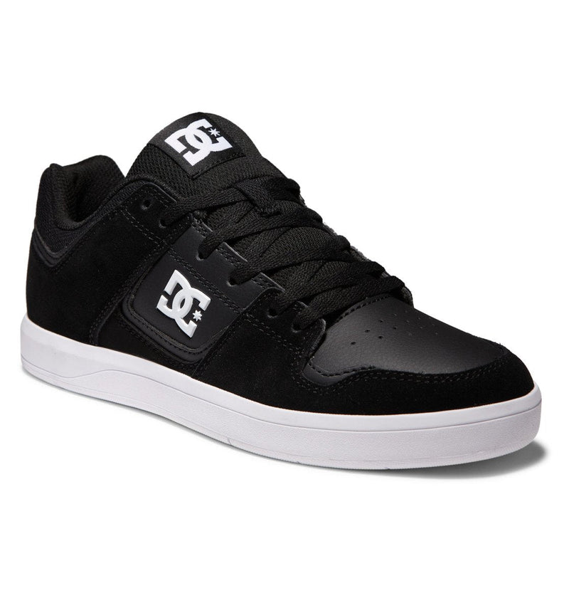 The Men's DC Cure Shoes by DC Shoes feature a black design with a white logo, black laces, and a white rubber sole—shown angled from the front-right side—making them perfect street-ready footwear for daily wear.