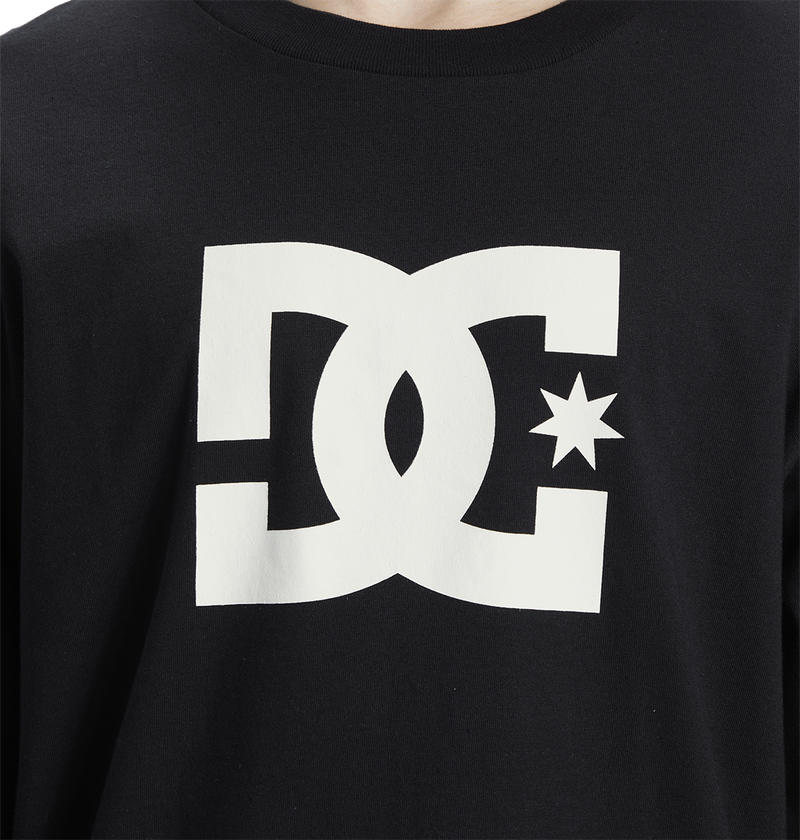 Close-up of the Men's DC Star Tee by DC Shoes, a black graphic shirt with a large white logo featuring stylized D and C letters, star detail, and bold front artwork—ideal for skate sessions.