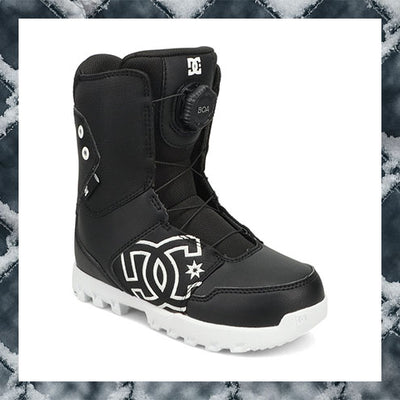 Black snowboard boot with white logo on a textured snowy background