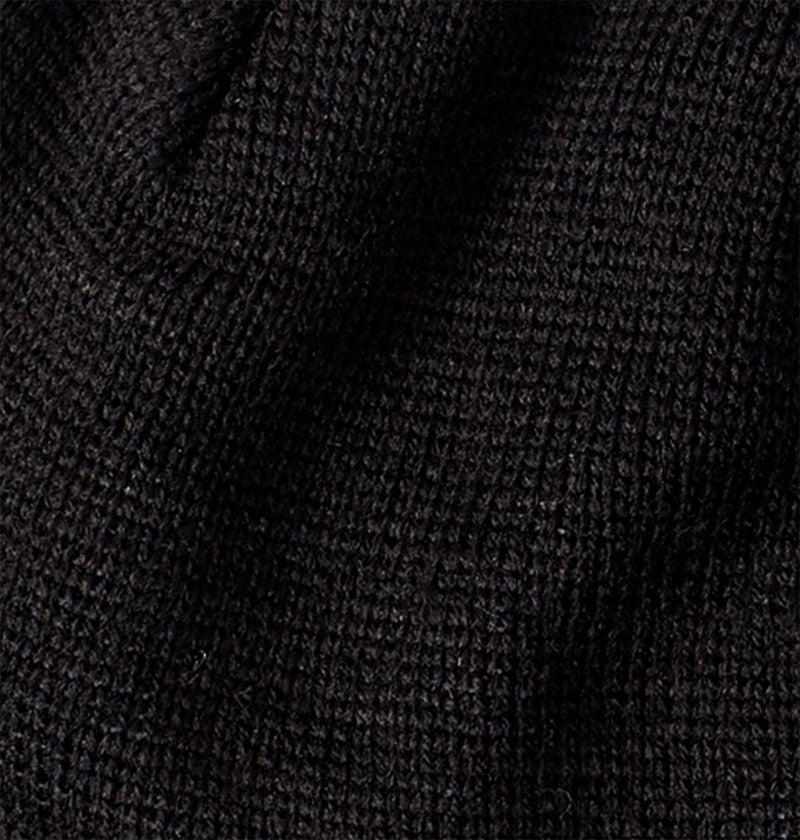 Close-up of the textured, knitted black fabric of the DC Shoes Big Star 2, crafted from recycled fibers. Visible stitching and subtle folds create dynamic shadows and highlights.