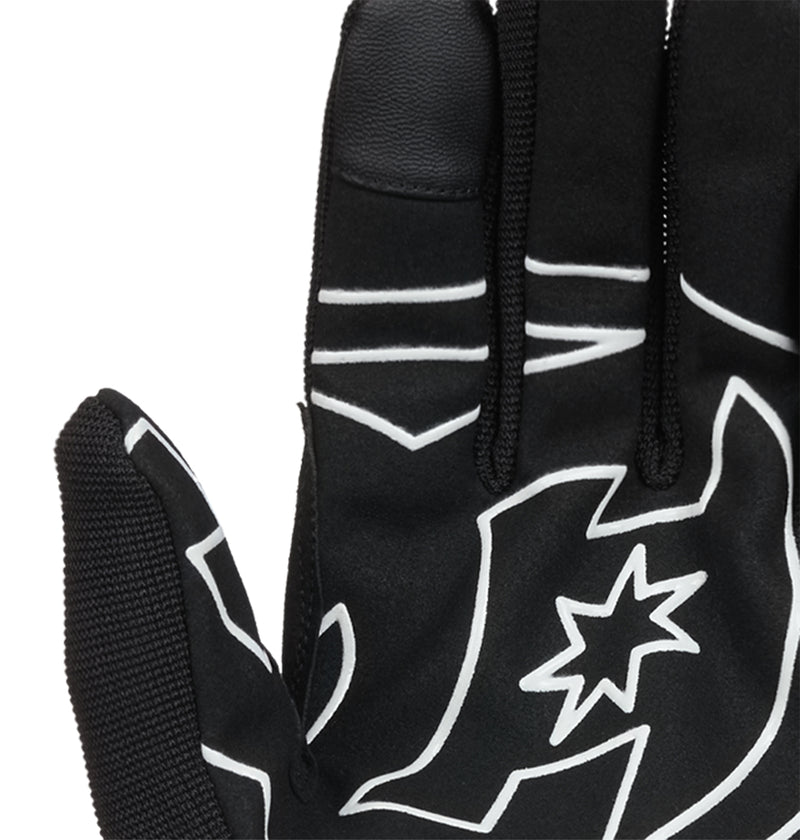 A close-up of the DC Shoes Trackstar Park Gloves in black, featuring distinctive white patterns and a star design on the back, showcases the palm side facing away and emphasizes their insulated warmth—making these snow gloves an ideal blend of style and comfort.