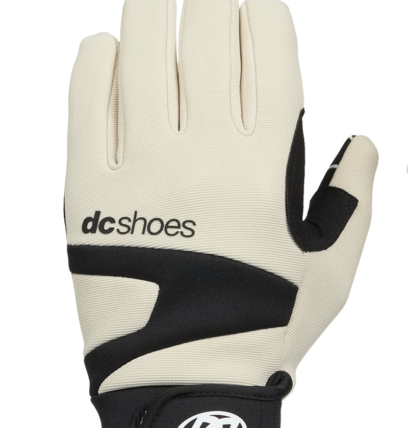 The DC Shoes Trackstar Park Gloves feature a beige and black design with the DC Shoes logo printed on the back. Shown with the palm facing outward and fingers extended, these gloves provide insulated warmth perfect for snow activities while maintaining a sleek, stylish appearance.