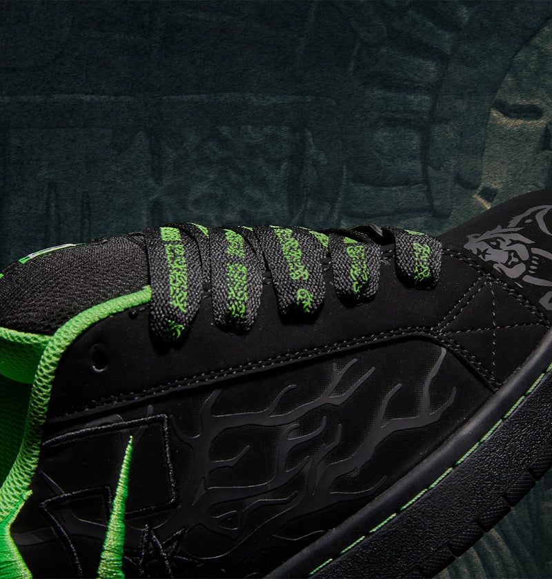 Black Men’s Court Graffik x Diablo skate shoe with bright green accents, patterned laces, and a flame-like graphic on the side.