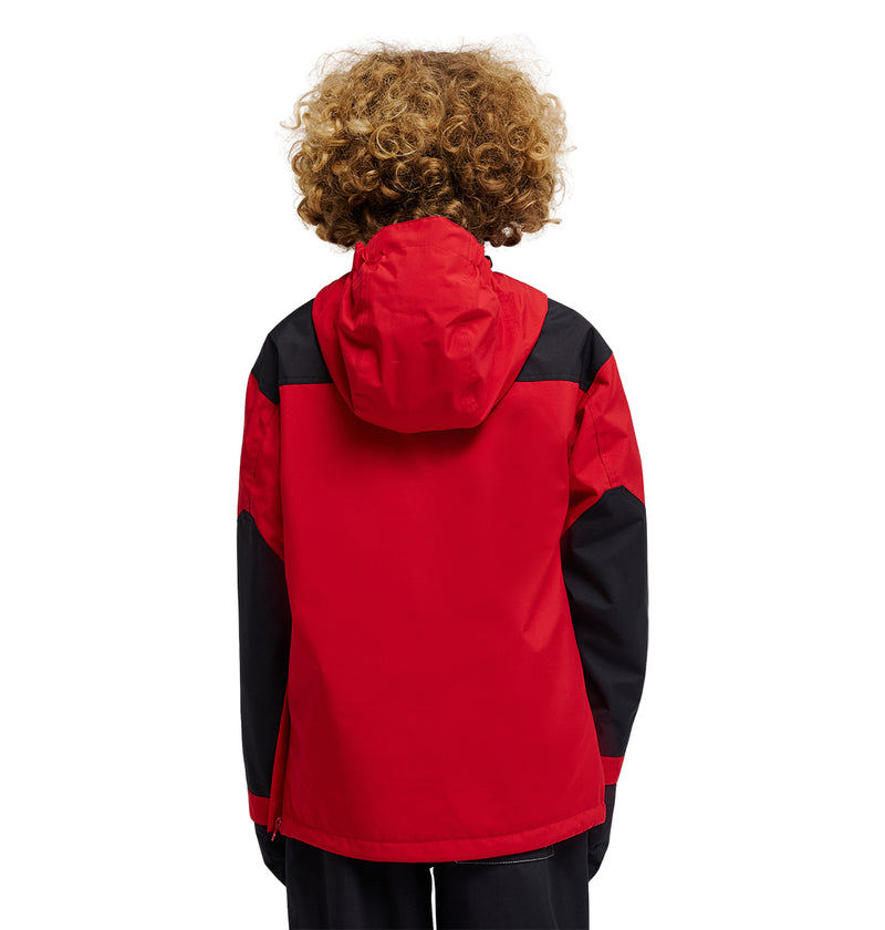 A person with curly hair is shown from the back, standing against a plain white background and wearing the DC-43 Youth Anorak insulated snow jacket by DC Shoes in red and black.