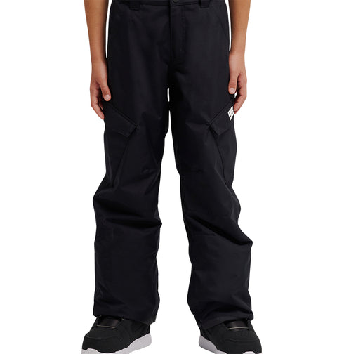 A person wearing DC Shoes Banshee Youth Pants—loose-fitting black cargo pants with waterproof insulation—and black sneakers, stands with arms relaxed at their sides, shown from shoulders to feet against a white background.