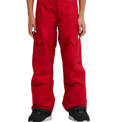 Individual wearing vibrant red DC Shoes Banshee Youth Pants and black shoes, shown from waist to feet, standing against a plain white background.