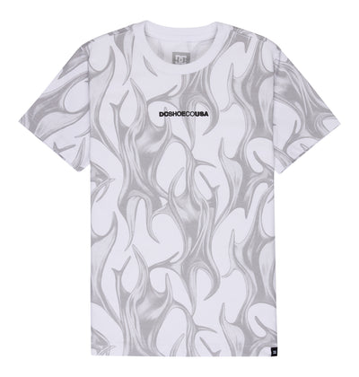 The Reebok DC Liquid Fuego Hss Youth is a white short-sleeve t-shirt featuring gray abstract flame patterns and "DCSHOECOUSA" in bold black text centered on the chest.