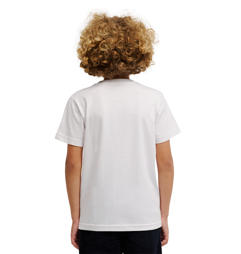 A child with curly blond hair stands facing away from the camera against a white background, wearing the DC Shoes DC Side Flame Tee Youth—a relaxed-fit graphic skate t-shirt featuring subtle flame artwork.