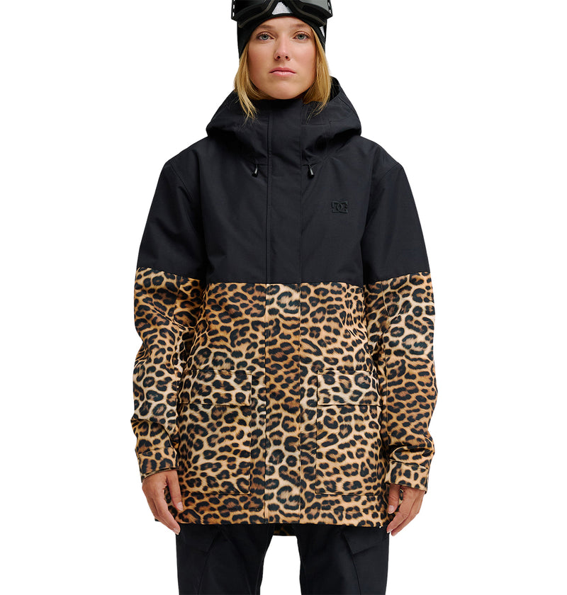 A person faces forward against a white background wearing the DC Shoes Cruiser Jacket in black and leopard print, paired with black ski goggles on their head.