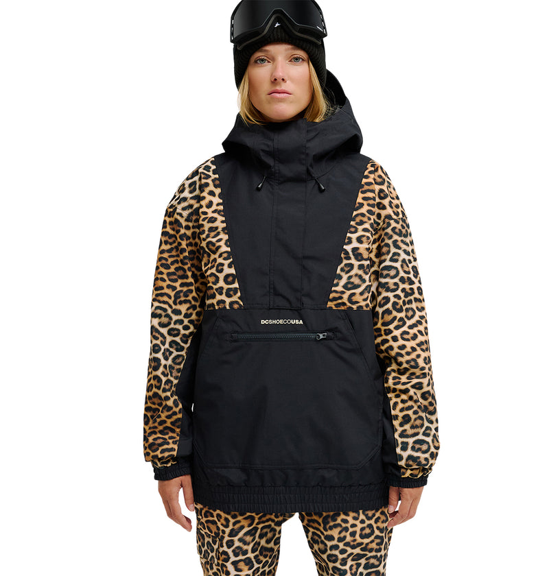 A person wearing ski goggles and a black DC Shoes Chalet Anorak with leopard print sleeves and matching pants stands facing forward against a white background. This outfit provides breathable protection and waterproofing, delivering ultimate comfort in any condition.